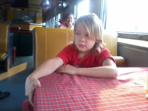 Noah waiting for his food in the restaurant carriage. He wants to grow his hair until his nineteen to see how long it will get...?! I think  it will look great in his surfing pics in Indo. :) 