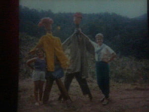 Extremely poor quality pic of my sister and myself (left) proudly displaying our handmade scarecrows. If only they had a brain!